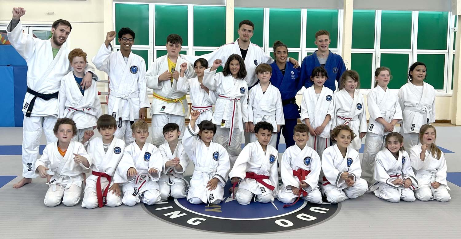 Core Judo students practicing throws and movement drills during a high-energy coaching session.